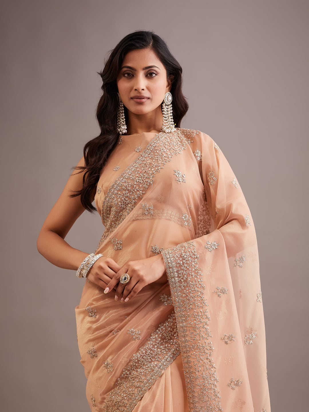 KASEE Women's peach Super Net Saree with Gold Zari Buti and Heavy Embroidered Border